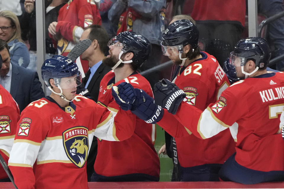 Florida Panthers center Carter Verhaeghe (23) celebrates a goal with teammates during the first period of an NHL hockey game against the Colorado Avalanche, Saturday, Feb. 10, 2024, in Sunrise, Fla. (AP Photo/Wilfredo Lee)