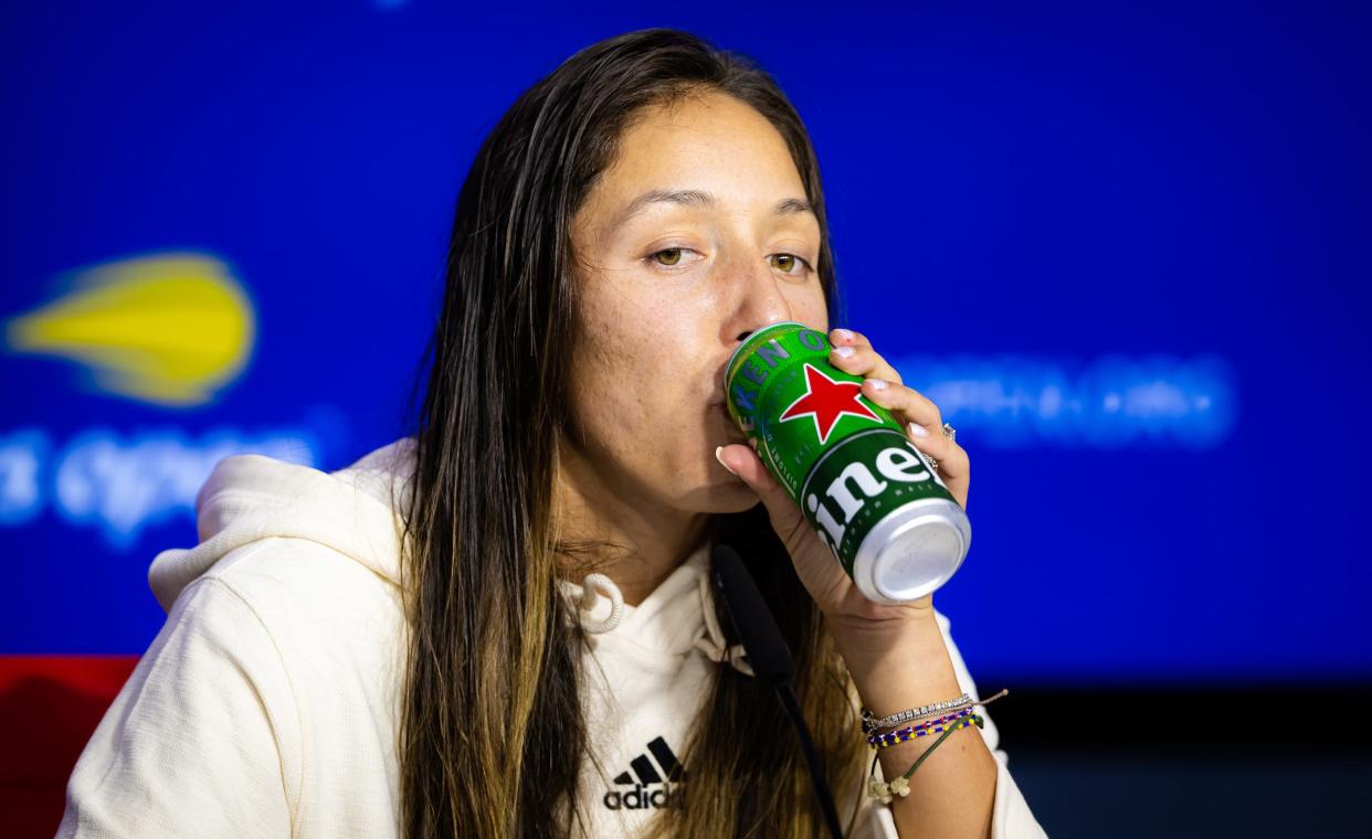 Jessica Pegula sips a beer during her post-match press conference.