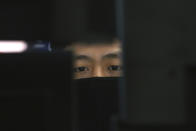 A currency trader wearing a face mask watches monitors at the foreign exchange dealing room of the KEB Hana Bank headquarters in Seoul, South Korea, Tuesday, March 10, 2020. Asian stock markets are taking a breather from recent declines. (AP Photo/Ahn Young-joon)