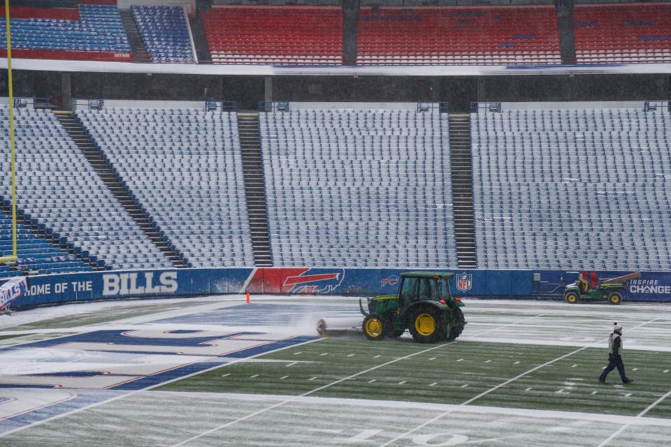Snow is cleared from the field at Highmark Stadium before the game between the Buffalo Bills and Atlanta Falcons on Jan. 2 in Orchard Park, N.Y.