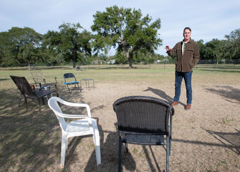 Escambia County District 2 Commissioner-elect Mike Kohler points out the improvements he would like to have done in the dog park at the Lexington Terrace Park in Warrington.