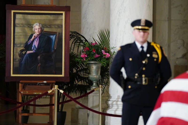 A 1999 portrait of Supreme Court Justice Sandra Day O'Connor by Danni Dawson stands near O'Connor's casket during her public repose in the Great Hall at the Supreme Court in Washington, D.C., on Monday. Photo by Bonnie Cash/UPI