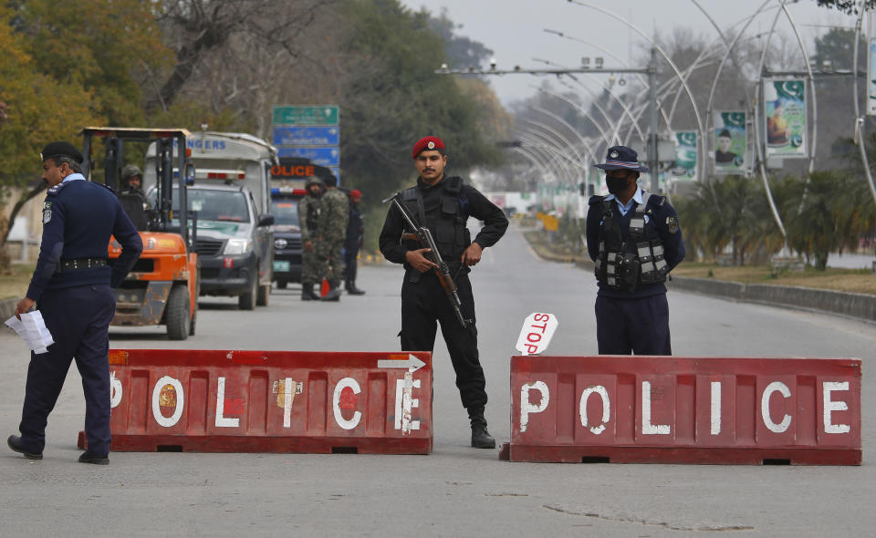 Pakistani police commandos and paramilitary soldiers stand guard at a highway to ensure security ahead of Saudi Arabia's crown prince visit to Pakistan, in Islamabad, Pakistan, Sunday, Feb. 17, 2019. Saudi Crown Prince Mohammed bin Salman will arrive in Islamabad on Sunday evening on an official visit that is expected to include the signing of agreements for billions of dollars of investment in Pakistan. (AP Photo/Anjum Naveed)