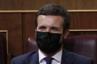 Popular Party leader of the opposition Pablo Casado laughs behind his face mask during a parliamentary session in Madrid, Spain, Wednesday Oct. 21, 2020. Spanish Prime Minister Pedro Sanchez faces a no confidence vote in Parliament put forth by the far right opposition party VOX. (AP Photo/Manu Fernandez, Pool)