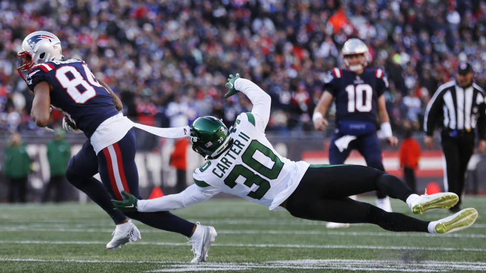 New York Jets cornerback Michael Carter II (30) dives but misses the tackle after a reception by New England Patriots wide receiver Kendrick Bourne (84) during the first half of an NFL football game, Sunday, Nov. 20, 2022, in Foxborough, Mass. (AP Photo/Michael Dwyer)