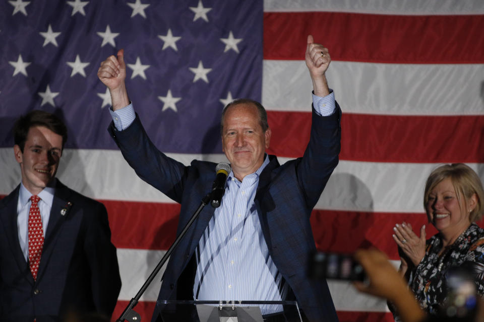 North Carolina 9th district Republican congressional candidate Dan Bishop celebrates his victory in Monroe, N.C., Tuesday, Sept. 10, 2019 with his son Jack, left, and wife Jo. (AP Photo/Nell Redmond)