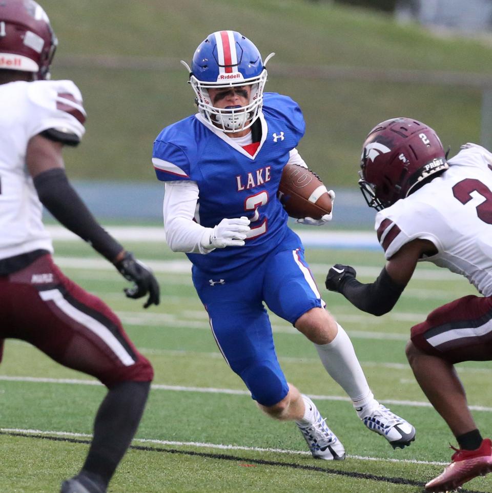 Nathan Baker of Lake picks up yardage during their game against Maple Heights at Lake on Friday, August 26, 2022.