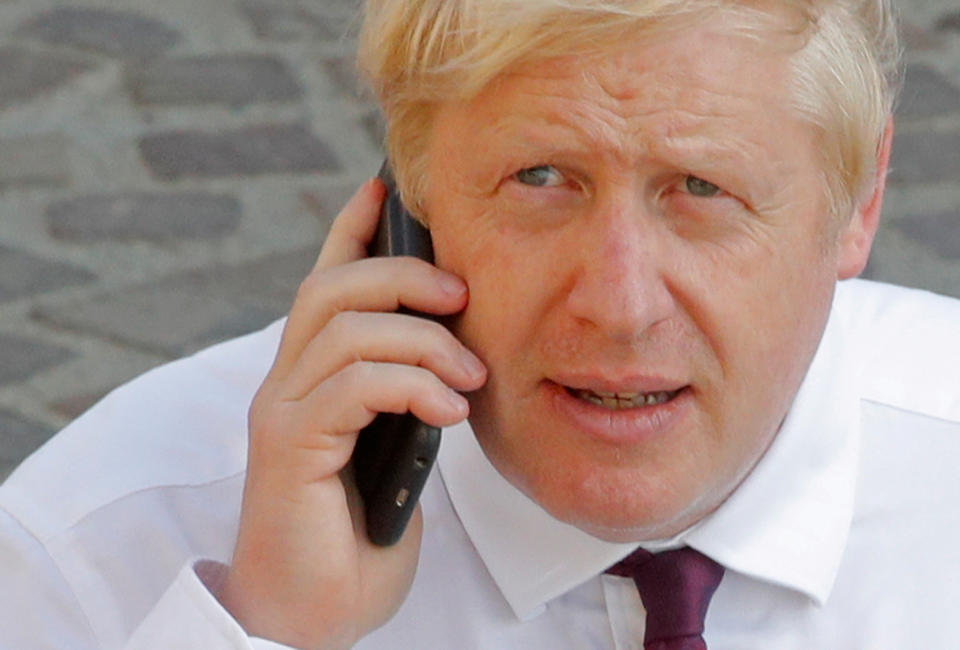 Britain's Prime Minister Boris Johnson makes a phone call as he walks near the summit venue during the G7 summit in Biarritz, France, August 25, 2019.  REUTERS/Philippe Wojazer