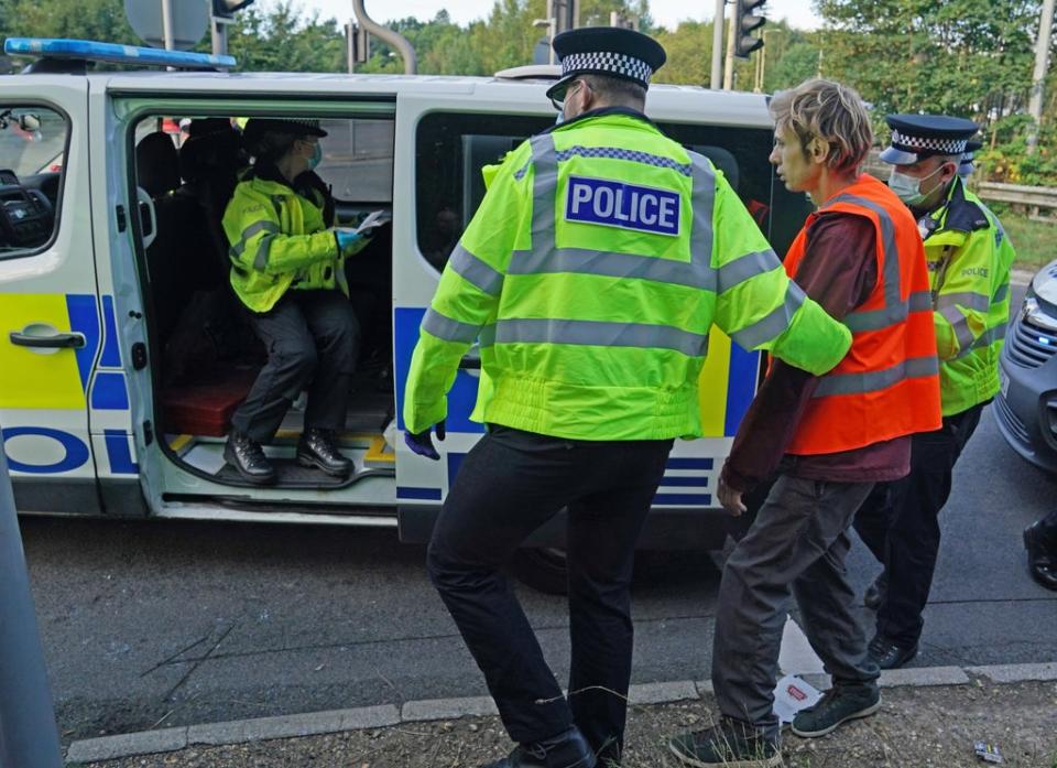 Officers lead a protester to a police van at a slip road at Junction 18 of the M25, near Rickmansworth (Steve Parsons/PA) (PA Wire)