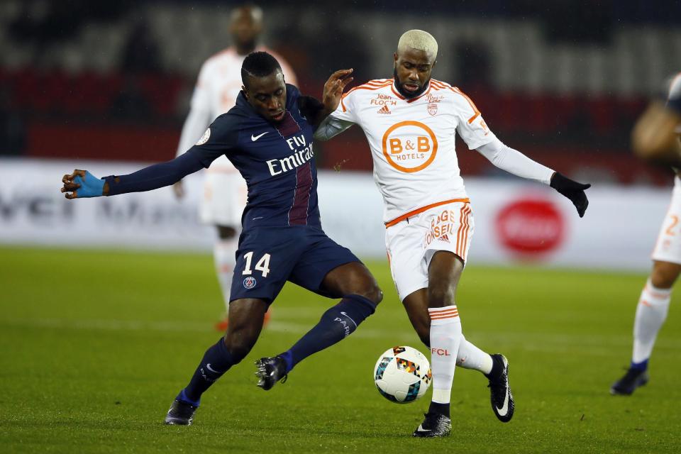 PSG's Blaise Matuidi, left, challenges for the ball with Lorient's Arnold Makengo Mvuemba during their French League One soccer match between PSG and Lorient at the Parc des Princes stadium in Paris, France, Wednesday, Dec. 21, 2016. (AP Photo/Francois Mori)