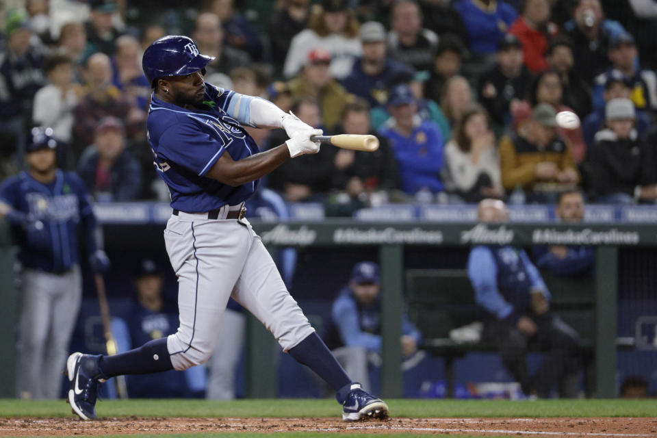 Tampa Bay Rays' Randy Arozarena singles to score Yandy Diaz during the second inning of the team's baseball game against the Seattle Mariners, Friday, May 6, 2022, in Seattle. (AP Photo/Jason Redmond)