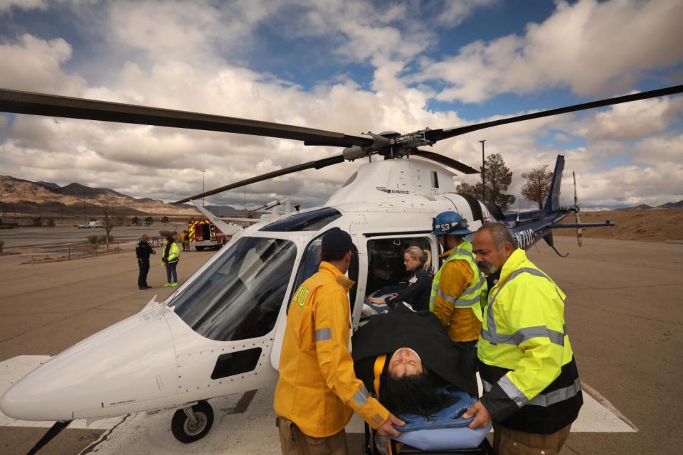 . First responders from Station 53 transport a car accident victim to a helicopter in Primm.