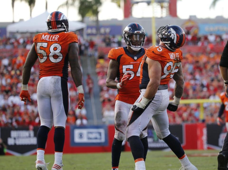 Oct 2, 2016; Tampa, FL, USA; Denver Broncos defensive end Derek Wolfe (95) celebrates with inside linebacker Brandon Marshall (54) and outside linebacker Von Miller (58) after he sacked Tampa Bay Buccaneers quarterback Jameis Winston (3) (not pictured) during the second half at Raymond James Stadium. Mandatory Credit: Kim Klement-USA TODAY Sports