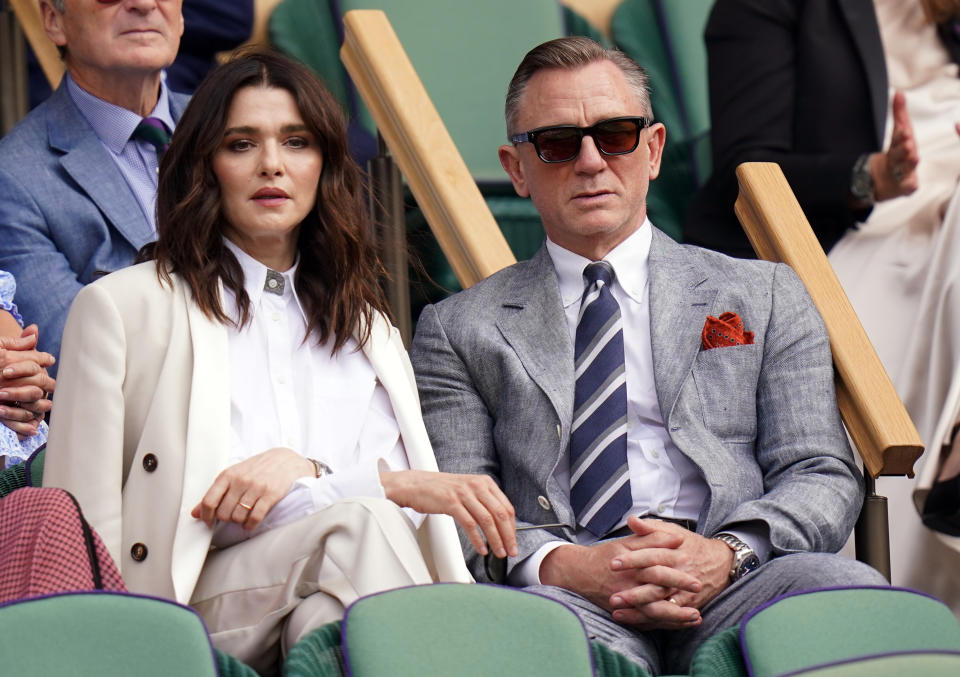 Rachel with her legs crossed and Daniel in a suit with his hands folded