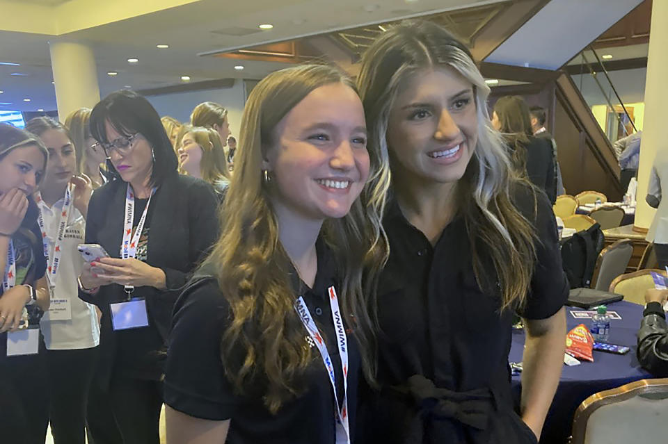 NASCAR driver Hailie Deegan, right, poses with 15-year-old Katie Hettinger, a Michigan racer who had just been announced as a participant in the Drive for Diversity combine, at the Women in Motorsports convention at Charlotte Motor Speedway in Concord, N.C., on Oct. 6, 2022. (AP Photo/Jenna Fryer)