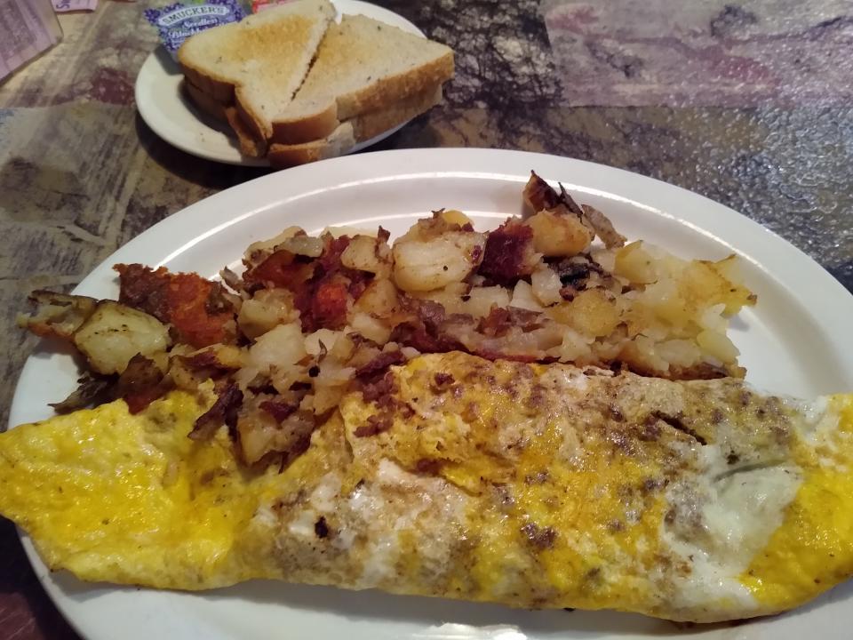 A three-egg omelet is served with home fries and toast at the Coventry Diner.