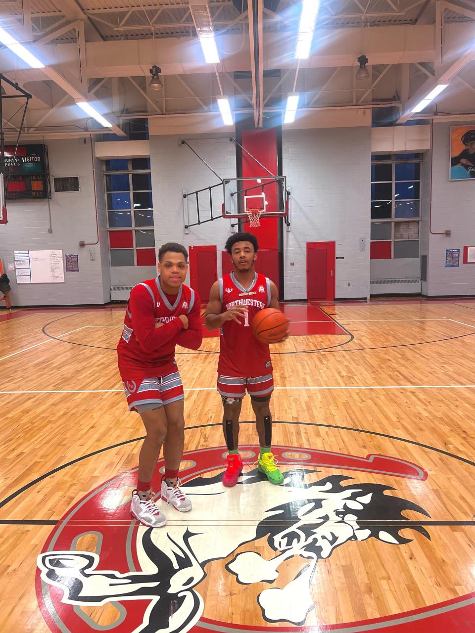 Cartier Woods, left, and Khanye Howard,, right, playing basketball for Northwestern High School.