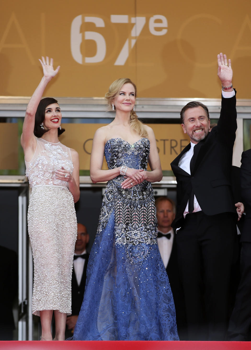 From left, actress Paz Vega, actress Nicole Kidman and actor Tim Roth stand at the top of the steps as they arrive for the opening ceremony and the screening of Grace of Monaco at the 67th international film festival, Cannes, southern France, Wednesday, May 14, 2014. (AP Photo/Alastair Grant)