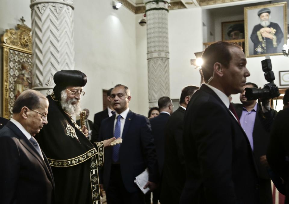 Lebanese President Michel Aoun, left, leaves after a meeting with Coptic Pope Tawadros II, second right, during his visit at St. Mark's Cathedral in Cairo, Egypt, Monday, Feb. 13, 2017. (AP Photo/Nariman El-Mofty)