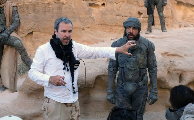 <p>Everett Collection</p> Denis Villeneuve and Javier Bardem on the set of 'Dune: Part Two'