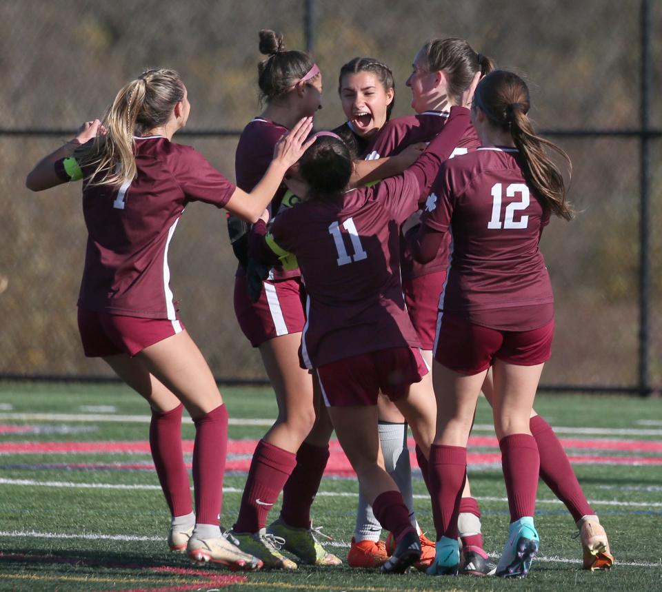 Aquinas players rush to celebrate with their goalkeeper Liz Tantalo, as the buzzer sounds giving Aquinas the 2-0 victory over Pittsford Sutherland in their Section V Class A girls soccer final.