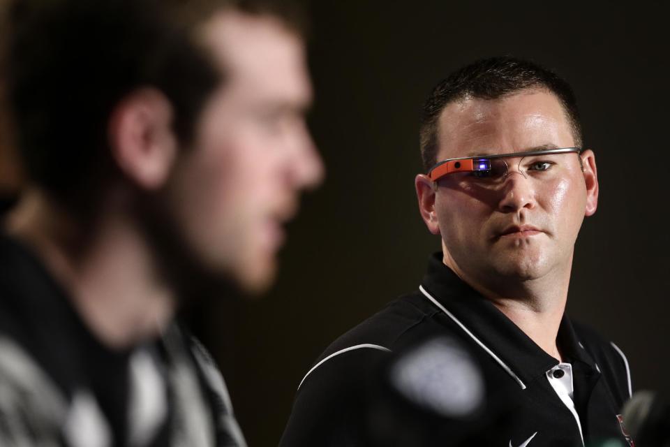 Stanford offensive coordinator Mike Bloomgren (R) wears Google Glass while listening to QB Kevin Hogan during a news conference on Friday, Dec. 27, 2013, in Los Angeles. (AP Photo/Jae C. Hong)