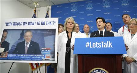 U.S. House Majority Leader Eric Cantor (R-VA) (4th R, at microphones) stands with Republican House members who are medical doctors as he addresses reporters during a news conference about restoring National Institutes of Health funding, at the U.S. Capitol in Washington, October 3, 2013. REUTERS/Jonathan Ernst