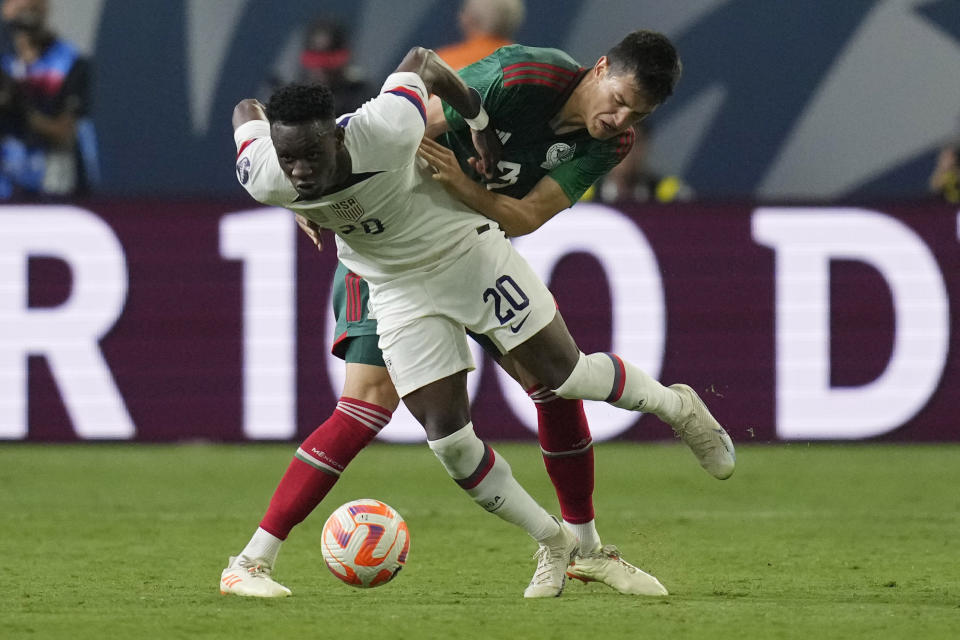 Folarin Balogun of the United States (20) battles for the ball with Cesar Montes of Mexico during the first half of a CONCACAF Nations League semifinal soccer match Thursday, June 15, 2023, in Las Vegas. (AP Photo/John Locher)