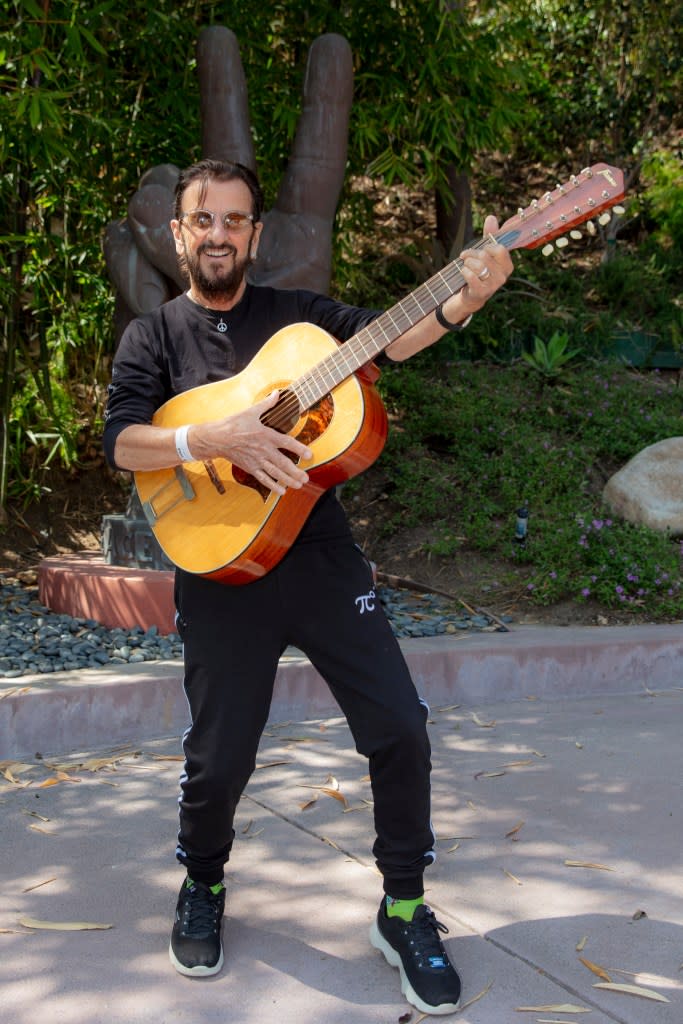 Ringo Star strums the recently found Lennon 12-string guitar. Scott Ritchie