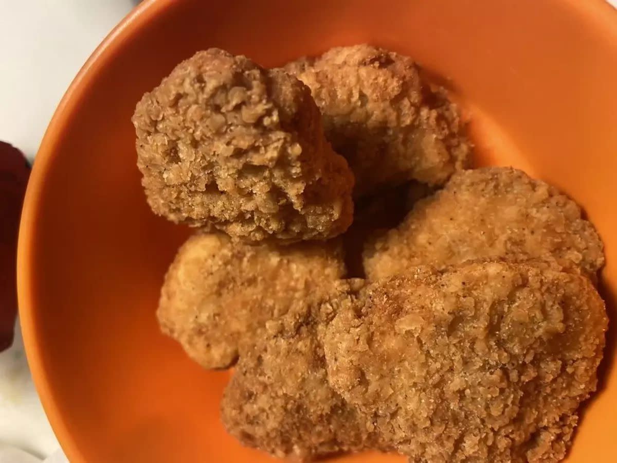 Closeup of Wendy's 6-piece chicken nuggets in an orange bowl