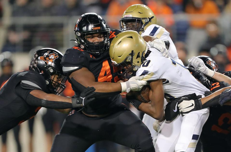 Hoban quarterback Tylan Boykin, right, is brought down by a host of Massillon defenders during the first half.