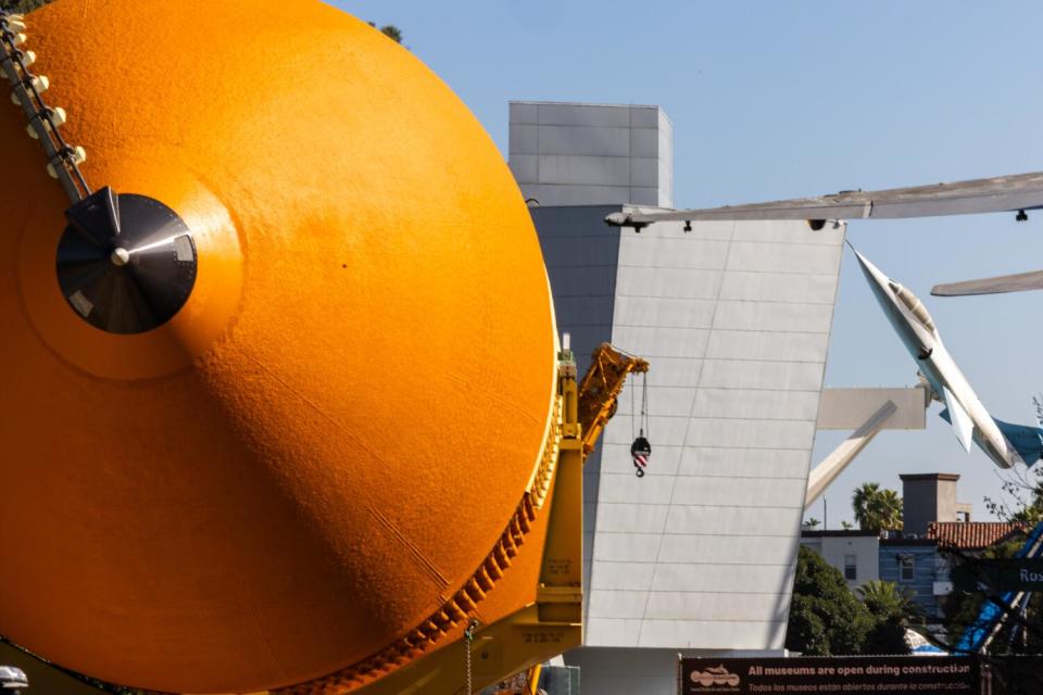 The giant orange fuel tank of the space shuttle Endeavor arrives at the California Science Center.
