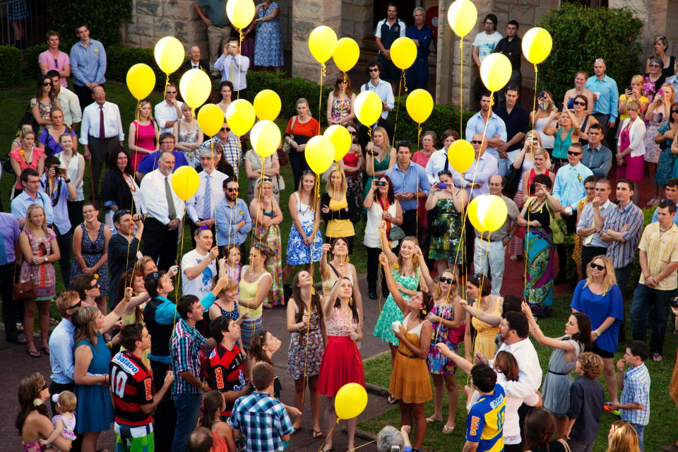 Twenty-three yellow balloons released at Sarah Frazer's wake attended by hundreds of people in NSW.