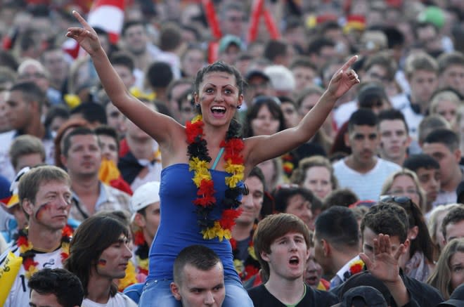 Supporters of the German national football team cheer up their team during the public screening of Germany's opening match against Portugal in the Euro 2012 football championships at the "Fanmeile" (Fan Mile) in Berlin on June 9, 2012. AFP PHOTO / MICHELE TANTUSSIMICHELE TANTUSSI/AFP/GettyImages