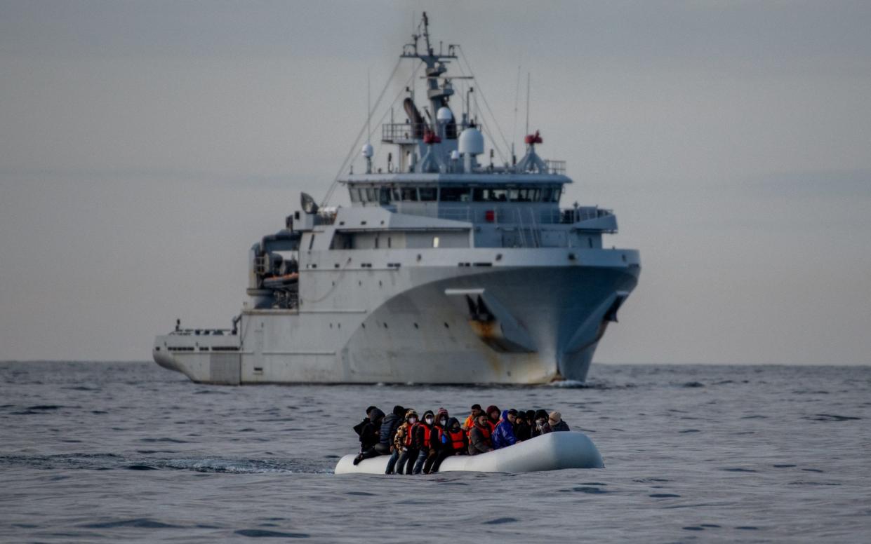 An inflatable dinghy carrying migrants passes a French navy vessel as it heads towards England. Sir Keir Starmer has suggested that greater cooperation with European countries is the best way to reduce illegal migration