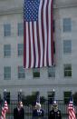 (L-R) U.S. President Barack Obama, Secretary of Defense Chuck Hagel, and Chairman of the Joint Chiefs of Staff U.S. Army General Martin Dempsey attend remembrance ceremonies for 9/11 at the Pentagon 9/11 Memorial in Washington September 11, 2013. The large flag in background marks the point of impact where a jetliner crashed into the Pentagon 12 years ago today. (REUTERS/Gary Cameron)