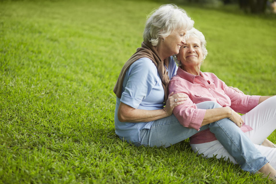 A couple laying in the grass together