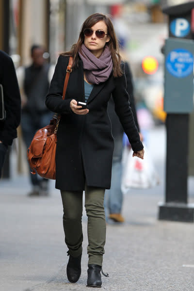 Olivia Wilde: The "Tron" actress is casual chic in a low cut black pea coat, dusty purple scarf, military green pants and a rust-coloured satchel. She accessorizes with aviators and black boots. Simple, yet effective. Picture by: GSNY / Splash News