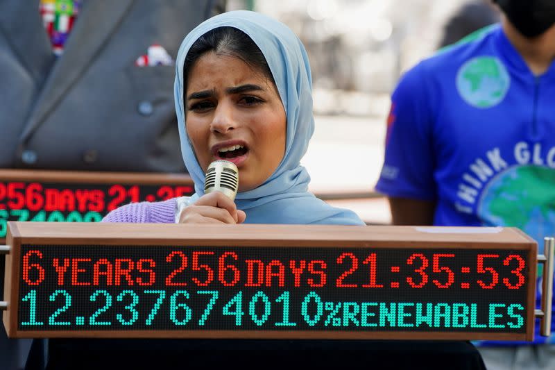 Climate activist Ayisha Siddiqa protests in advance of Earth Day in front of the Climate Clock in New York