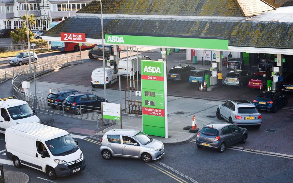 Brighton UK 24th September 2021 - Customers queue for fuel at a supermarket petrol station in Brighton this morning - Simon Dack News/Alamy Live News