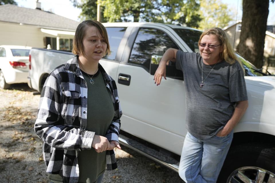 Caston Peters and their mom, Kim Michaelis-Peters, speak about restricting students from using pronouns or names that don't match their sex assigned at birth, Friday, Oct. 6, 2023, in Indianapolis. Indiana is among at least 10 states that have enacted laws prohibiting or restricting students from using pronouns or names that don't match their sex assigned at birth, a restriction that opponents say further marginalizes transgender and nonbinary students. (AP Photo/Darron Cummings)