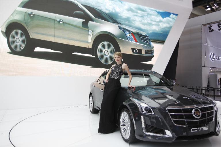 A model poses by a Cadillac CTS car at the "Auto China 2014" Beijing International Automotive Exhibition in Beijing on April 21, 2014