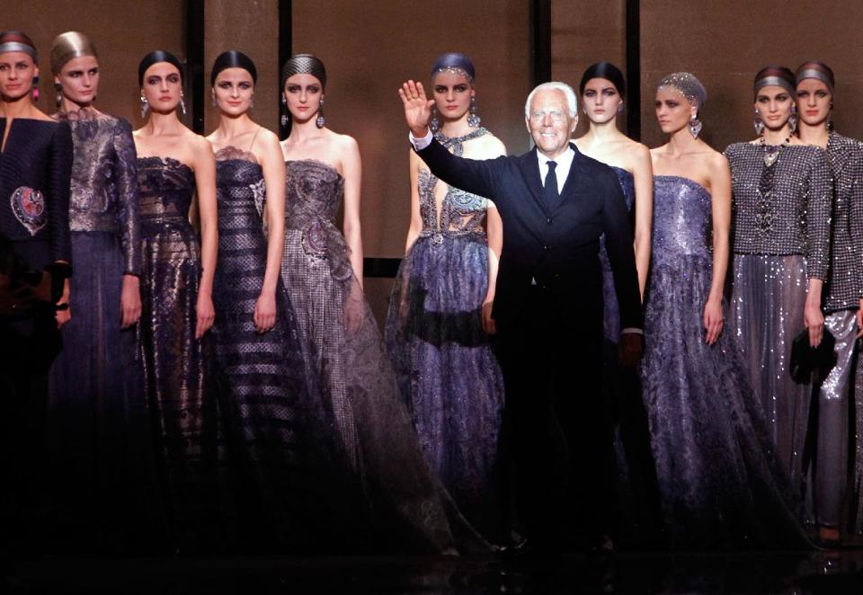 Fashion designer Giorgio Armani, foreground right, surrounded by models, acknowledges applause following the presentation of the Giorgio Armani Prive Spring-Summer 2014 Haute Couture fashion collection, presented Tuesday, Jan. 21, 2014 in Paris. (AP Photo/Thibault Camus)