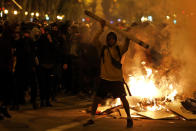 Protestors start fires in the street during clashes with police in Barcelona, Spain, Wednesday, Oct. 16, 2019. Spain's government said Wednesday it would do whatever it takes to stamp out violence in Catalonia, where clashes between regional independence supporters and police have injured more than 200 people in two days. (AP Photo/Emilio Morenatti)