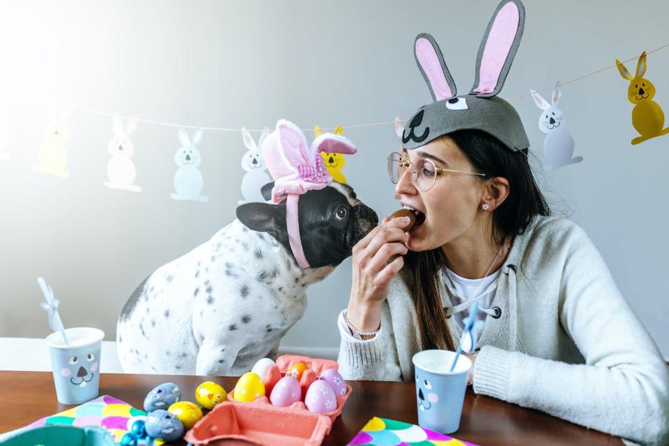 Do not share your chocolates with your pooch. <a href="https://www.gettyimages.com/detail/photo/dog-and-woman-with-costume-and-easter-decorations-royalty-free-image/1359250422" rel="nofollow noopener" target="_blank" data-ylk="slk:F.J. Jimenez/Moment via Getty Images;elm:context_link;itc:0;sec:content-canvas" class="link ">F.J. Jimenez/Moment via Getty Images</a>