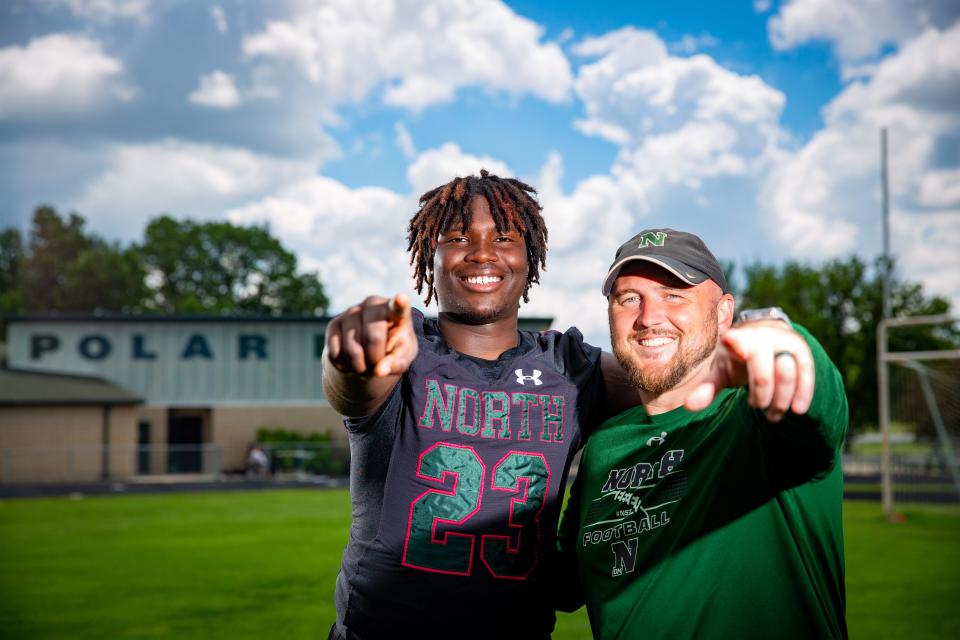 Des Moines North football player David Caulker and his coach Eric Addy stand for a photo on the field, Wednesday, June 8, 2022. Caulker has recently committed to play for the Hawkeyes.