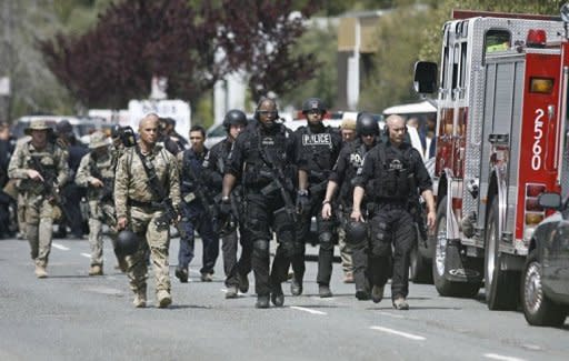 SWAT officers walk the area at a private religious college in Oakland, California. Seven people were killed Monday in a shooting at a private religious college near San Francisco, the head of the local city council said
