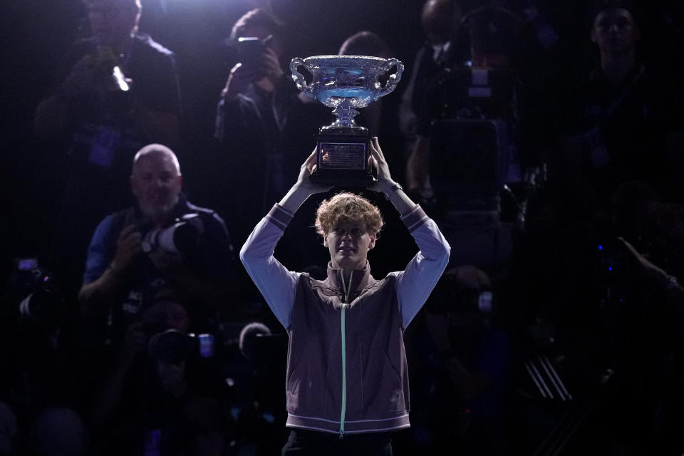 Jannik Sinner of Italy holds the Norman Brookes Challenge Cup aloft after defeating Daniil Medvedev of Russia in the men's singles final at the Australian Open tennis championships at Melbourne Park, in Melbourne, Australia, Sunday, Jan. 28, 2024. (AP Photo/Alessandra Tarantino)