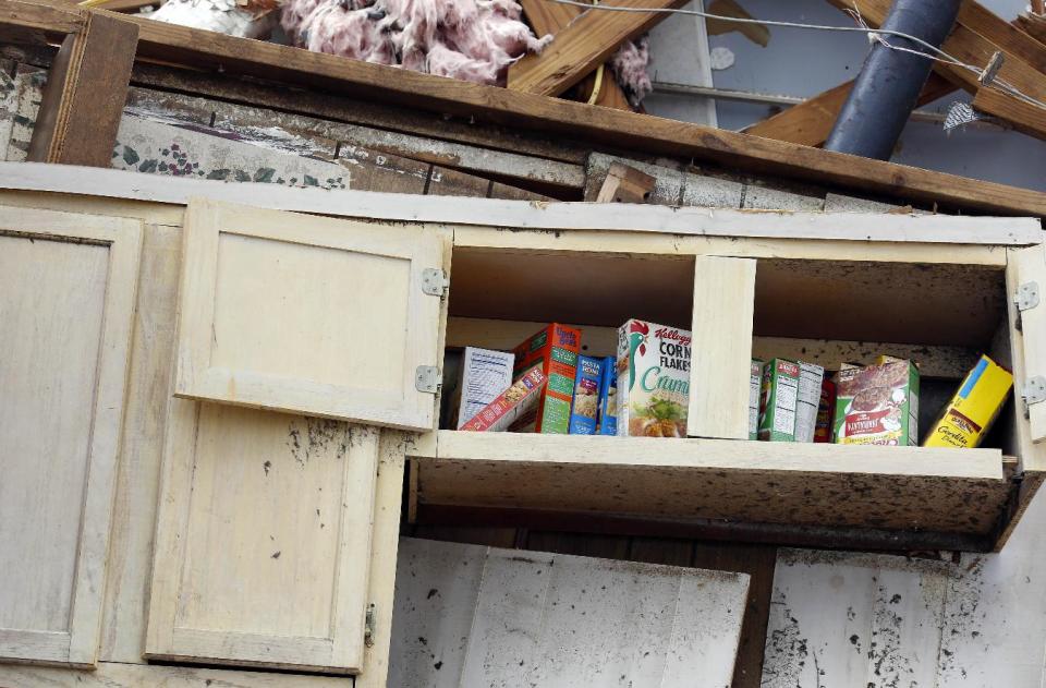 Boxes of food lie in an open kitchen cabinet in what remains of this south Louisville, Miss. home on Tuesday, April 29, 2014. Numerous businesses, residences and the community hospital were destroyed or heavily damaged after a tornado hit the east Mississippi community Monday. (AP Photo/Rogelio V. Solis)