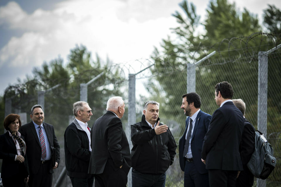 In this handout photo provided by the Hungarian Prime Minister's Press Office shows Hungarian Prime Minister Viktor Orban, center, Italian Interior Minister Matteo Salvini, third right, and Hungarian Interior Minister Sandor Pinter, third left, during their visit at the Hungarian-Serbian border near Roszke, 180 kms southeast of Budapest, Hungary, Thursday, May 2, 2019. (Balazs Szecsodi/Hungarian Prime Minister's Press Office/MTI via AP)